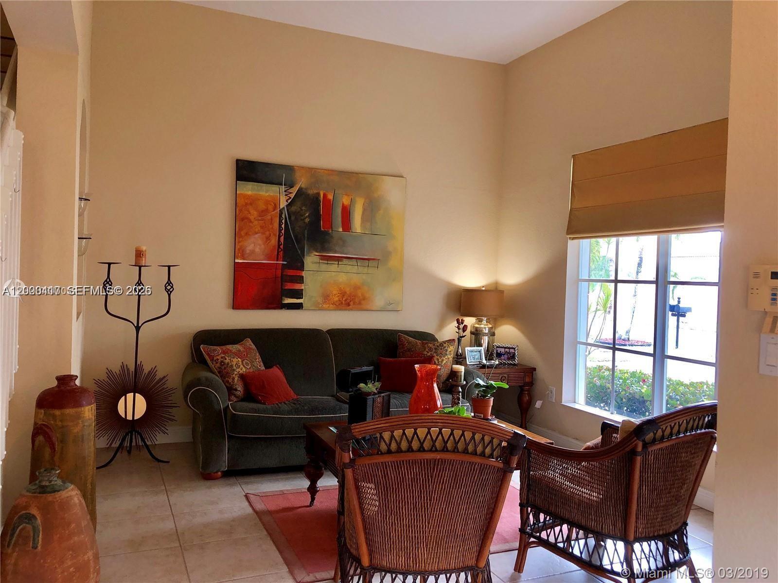 867 Southwest 155th Court, Unit 867 Miami, FL 33194 - Photo 2 of 25 a living room with furniture and a fireplace