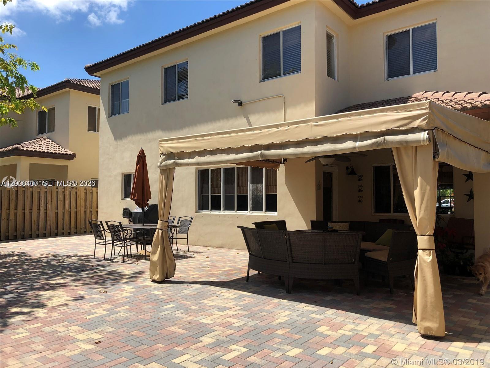 867 Southwest 155th Court, Unit 867 Miami, FL 33194 - Photo 23 of 25 a view of a house with a patio