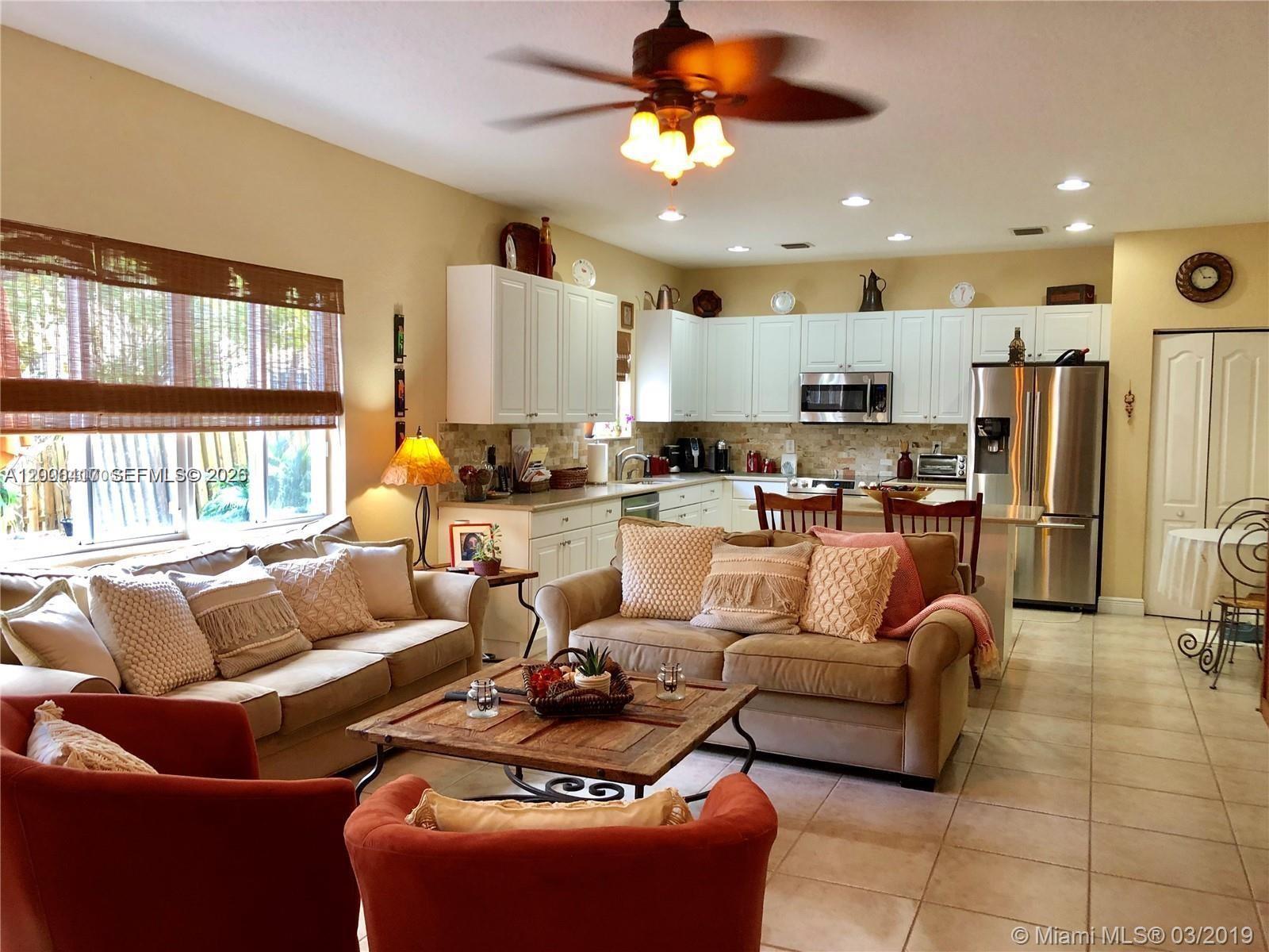 867 Southwest 155th Court, Unit 867 Miami, FL 33194 - Photo 4 of 25 a living room with furniture kitchen and a view of kitchen