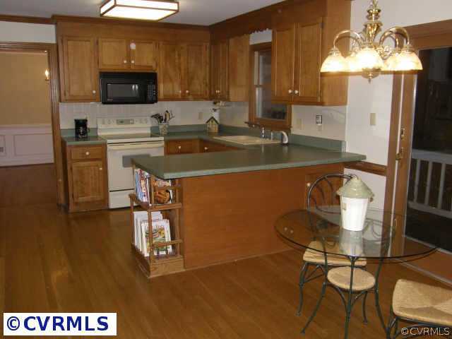 13020 Drakewood Road Midlothian, VA 23113 - Photo 8 of 10 a kitchen with a sink cabinets and microwave
