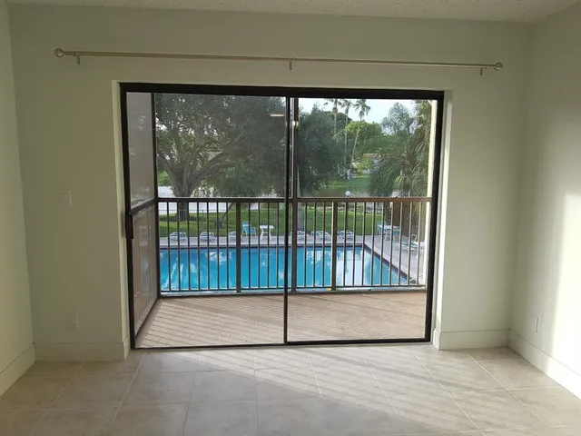 a view of empty room with sliding glass door