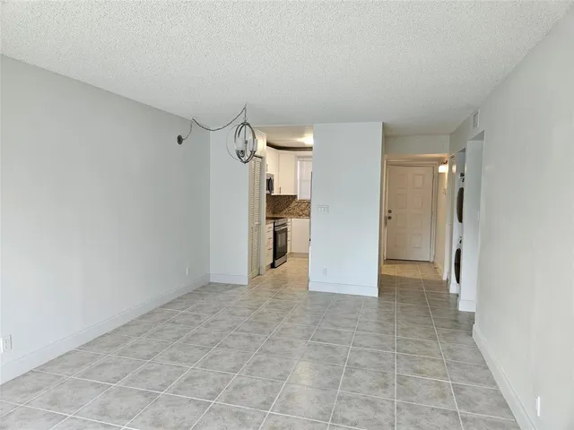 a view of a kitchen with refrigerator and a sink