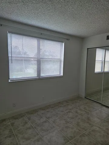 an empty room with a empty space and windows