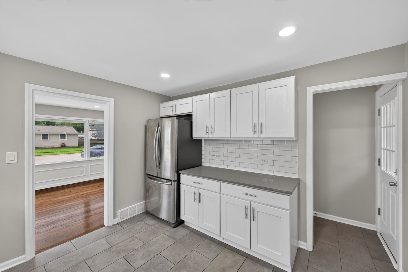 415 Alma Terrace Cary, IL 60013 - Photo 12 of 23 a kitchen with white cabinets and refrigerator