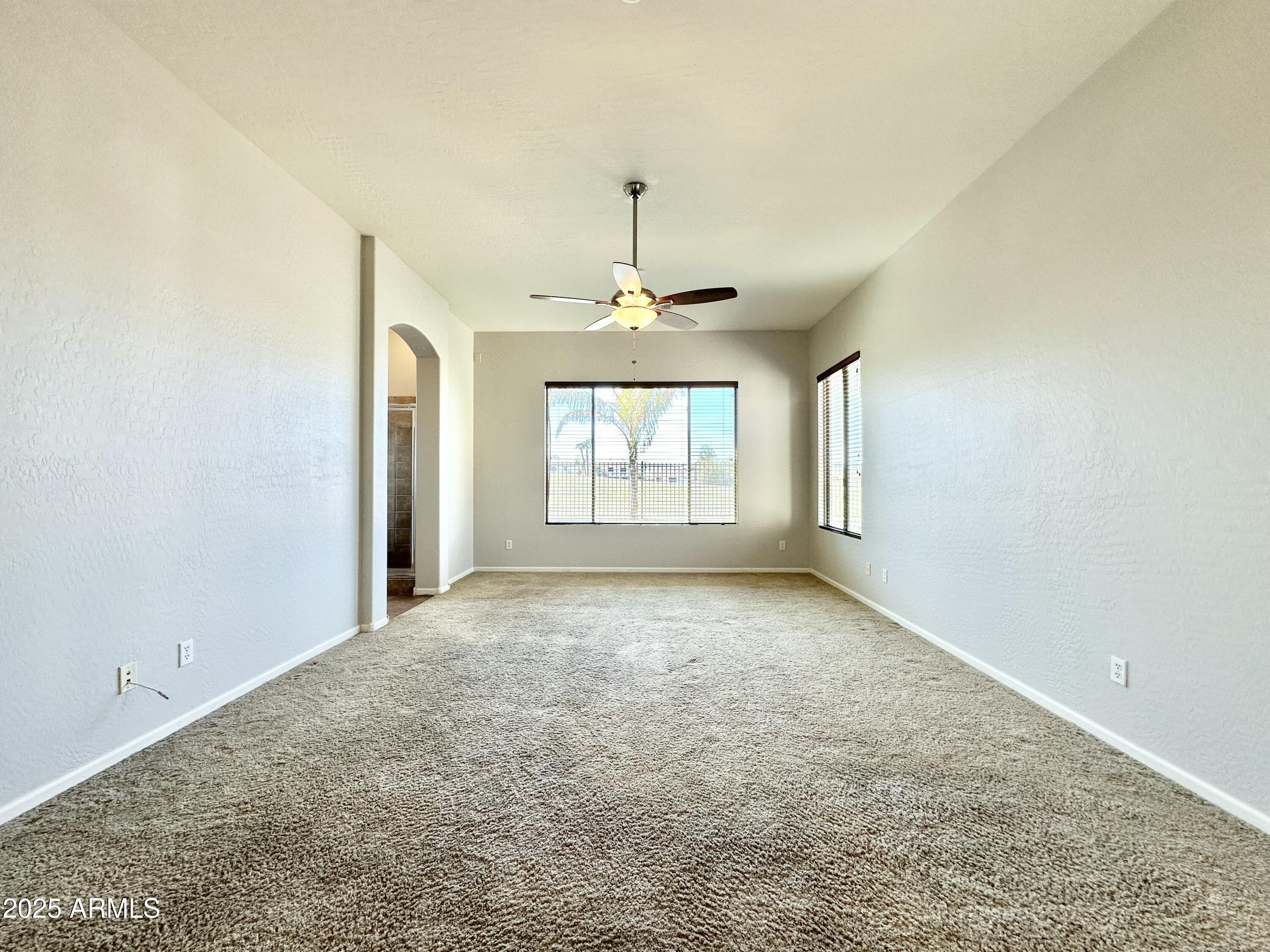 6562 South Crestview Drive Gilbert, AZ 85298 - Photo 13 of 23 an empty room with windows and chandelier