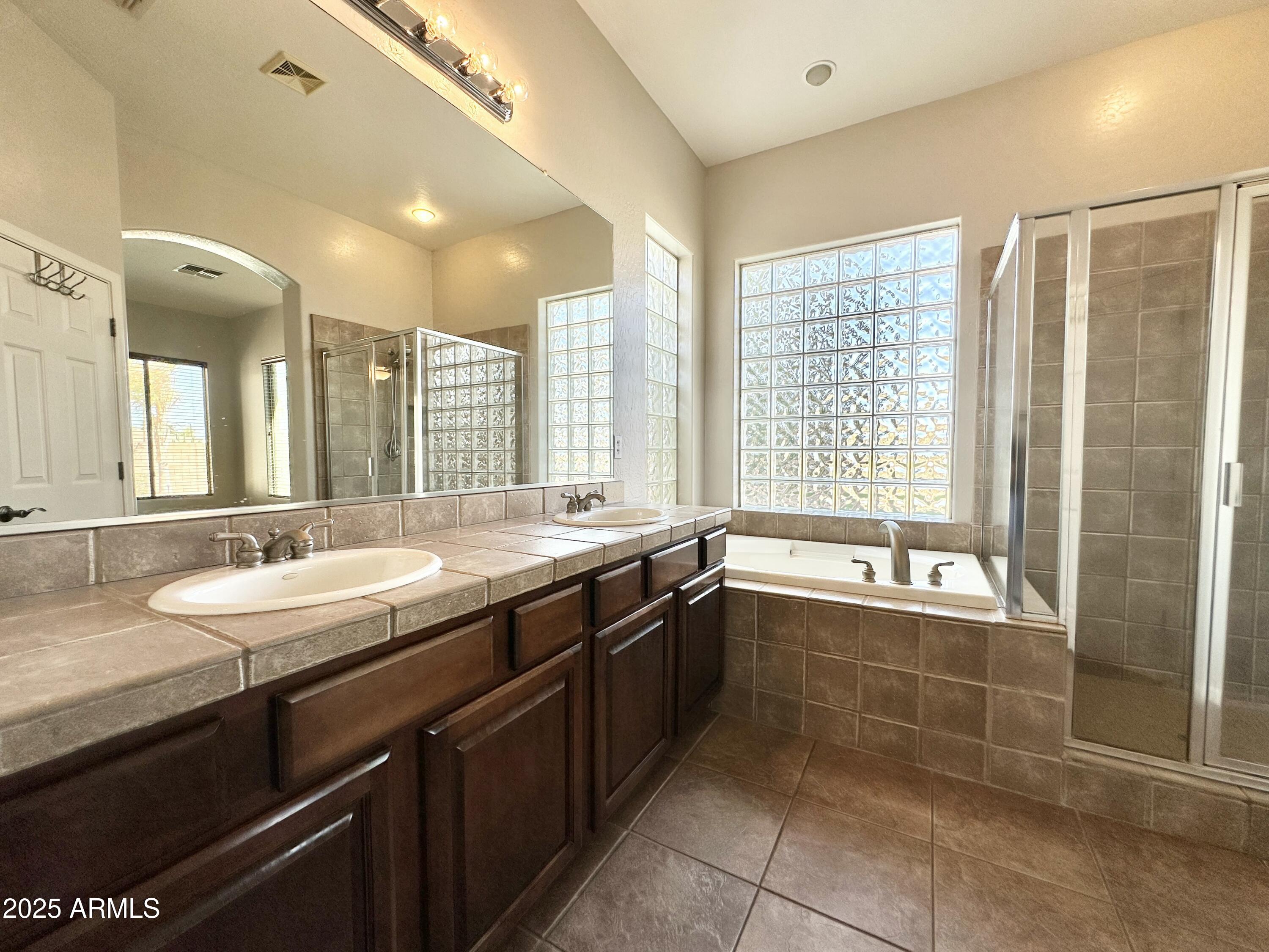 6562 South Crestview Drive Gilbert, AZ 85298 - Photo 14 of 23 a bathroom with a granite countertop sink and a bathtub
