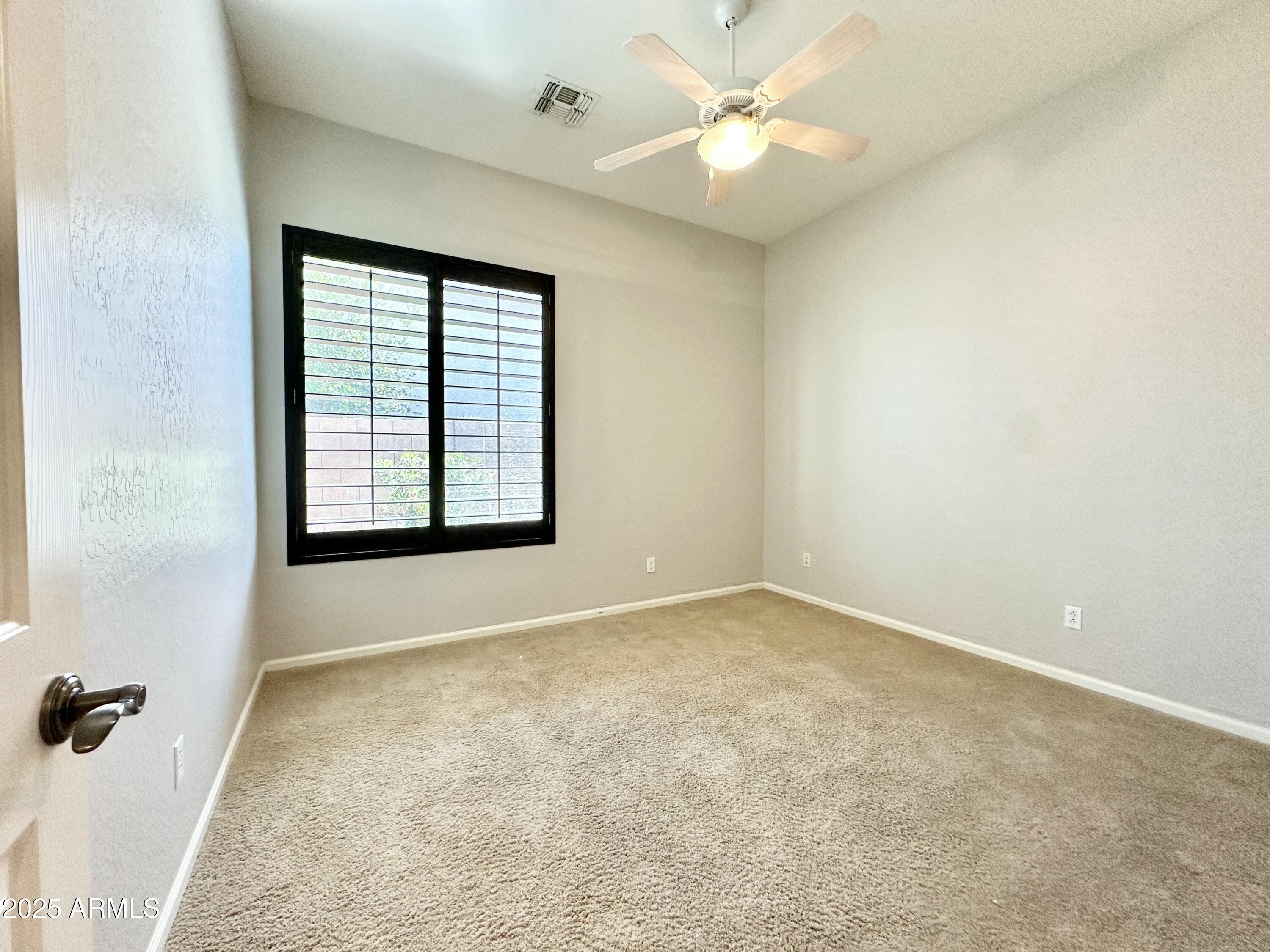 6562 South Crestview Drive Gilbert, AZ 85298 - Photo 16 of 23 an empty room with windows and fan