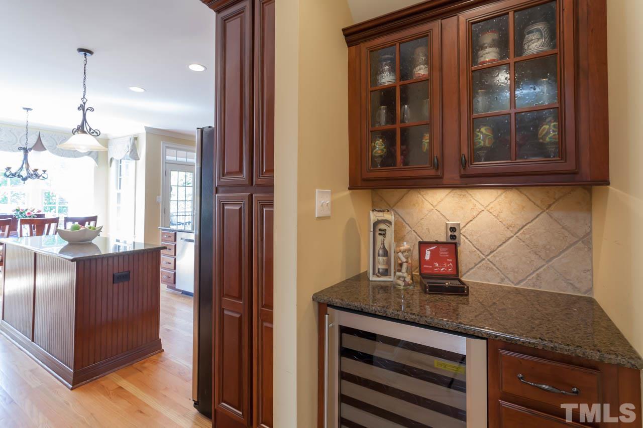 4218 Batiste Road Raleigh, NC 27613 - Photo 13 of 25 BUTLER'S PANTRY WITH BEAUTIFUL CABINETRY AND MINI-FRIDGE.