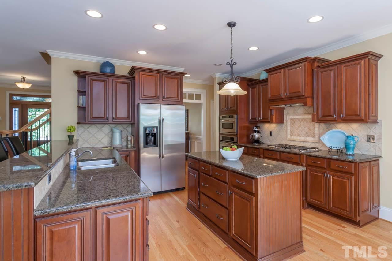 4218 Batiste Road Raleigh, NC 27613 - Photo 15 of 25 BEAUTIFUL CABINETRY, STAINLESS APPLIANCES, CENTER ISLAND AND GRANITE COUNTERTOPS.