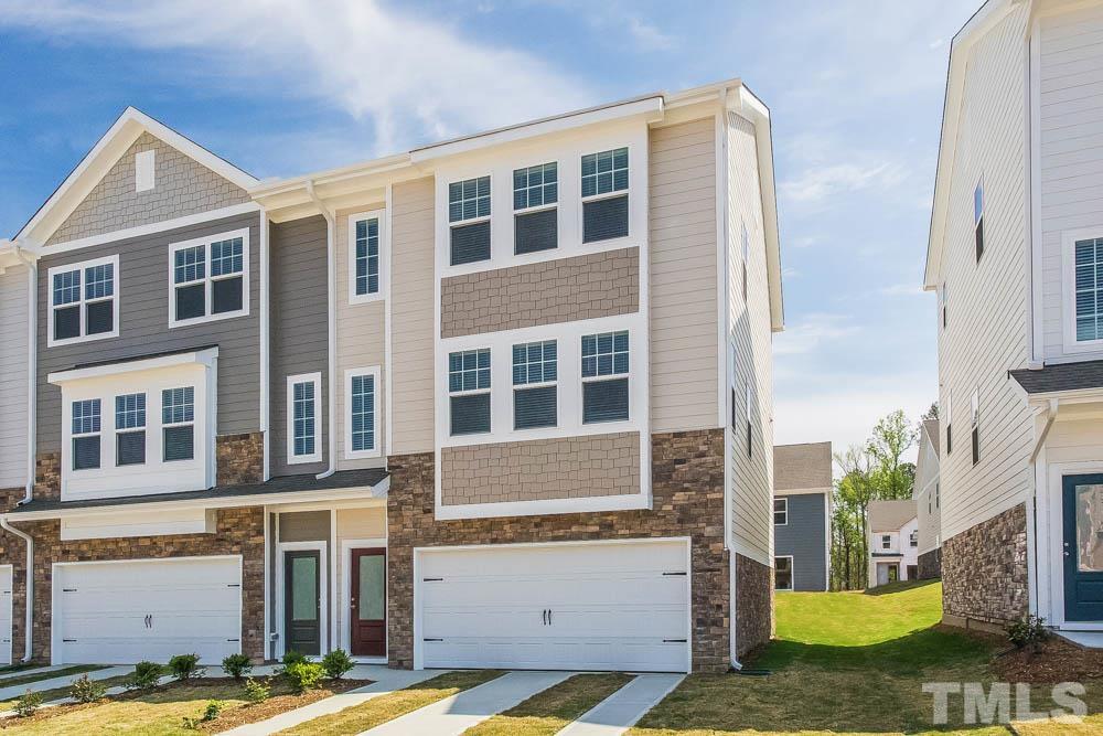 5222 Stream Stone Way Raleigh, NC 27616 - Photo 1 of 12 a front view of a building with a garden