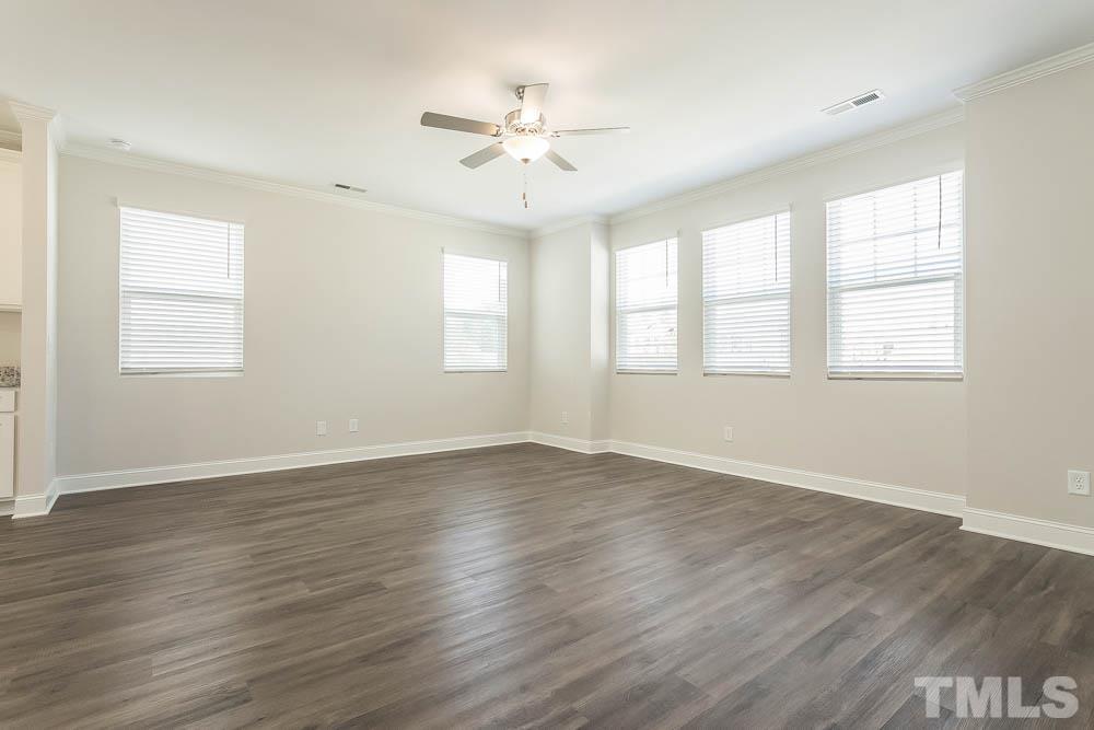 5222 Stream Stone Way Raleigh, NC 27616 - Photo 2 of 12 an empty room with wooden floor and windows