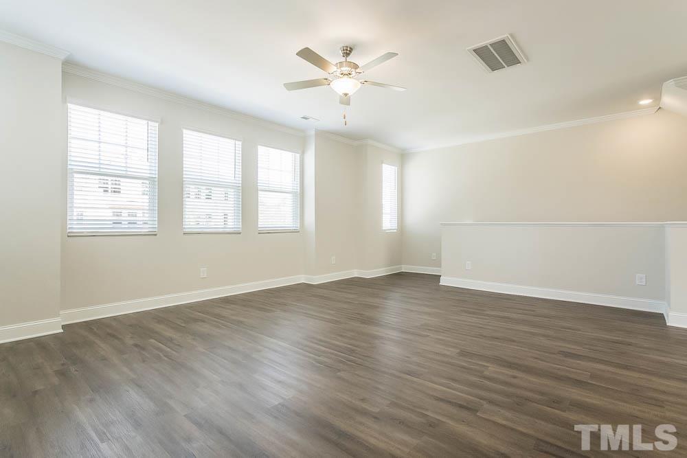 5222 Stream Stone Way Raleigh, NC 27616 - Photo 4 of 12 an empty room with wooden floor and windows