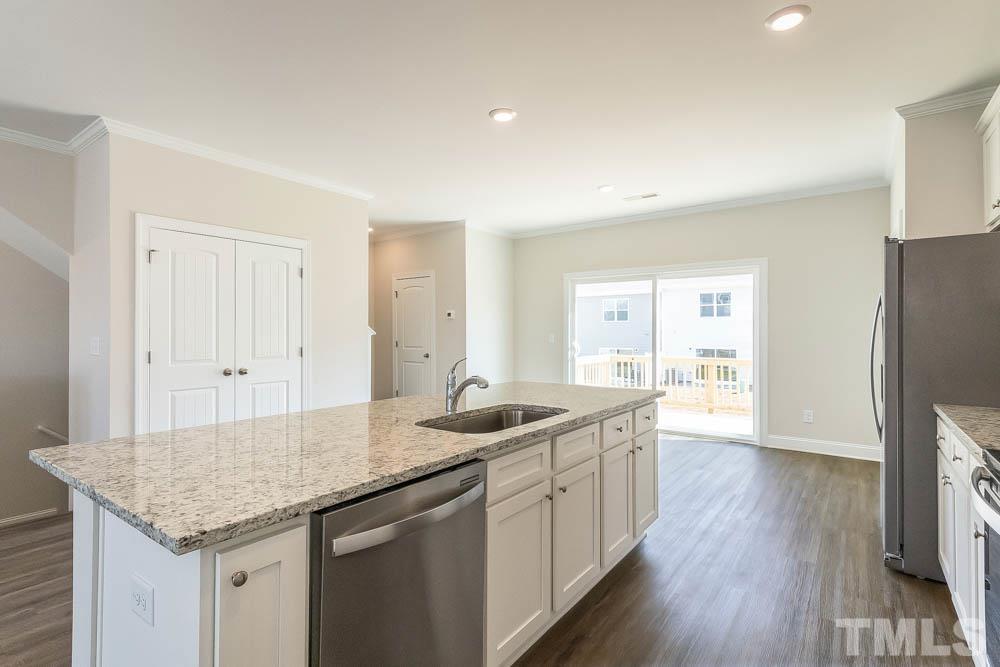 5222 Stream Stone Way Raleigh, NC 27616 - Photo 5 of 12 a kitchen with granite countertop a sink and a refrigerator