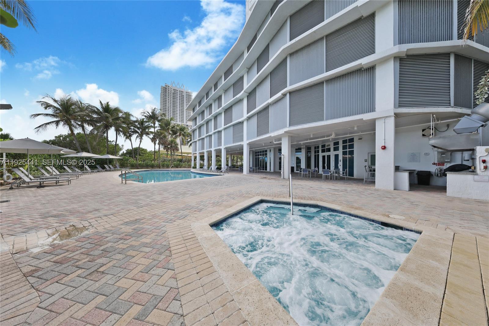 6515 Collins Avenue, Unit 605 Miami Beach, FL 33141 - Photo 17 of 18 a view of a building with a yard