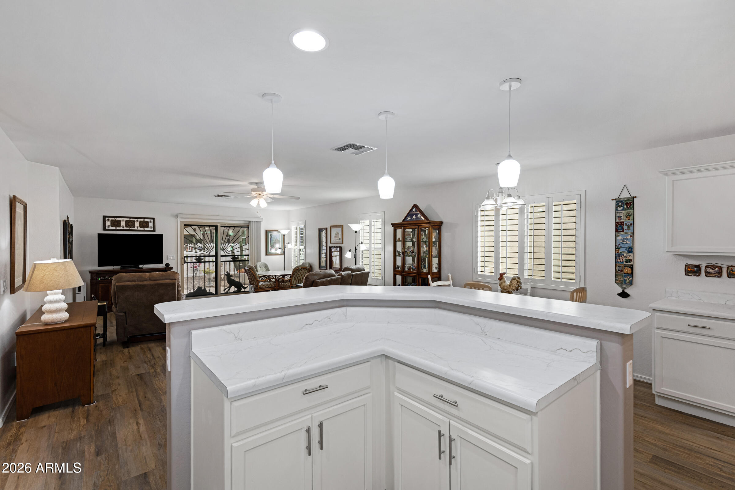 2101 South Meridian Road, Unit 199 Apache Junction, AZ 85120 - Photo 11 of 26 a large white kitchen with a large island oven a sink and a large window