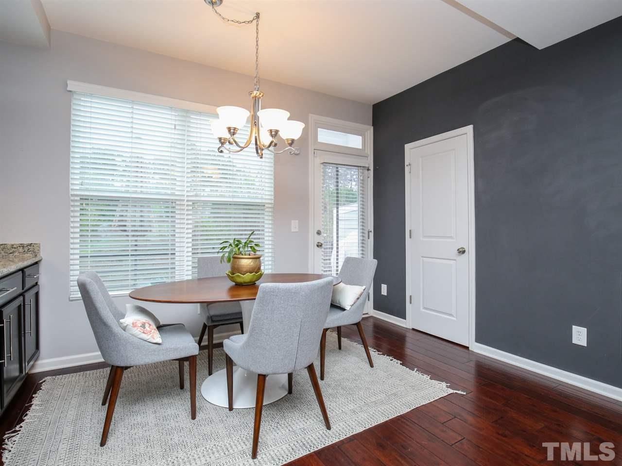 1415 Ardara Lane Raleigh, NC 27607 - Photo 8 of 30 a view of a dining room with furniture wooden floor and a chandelier