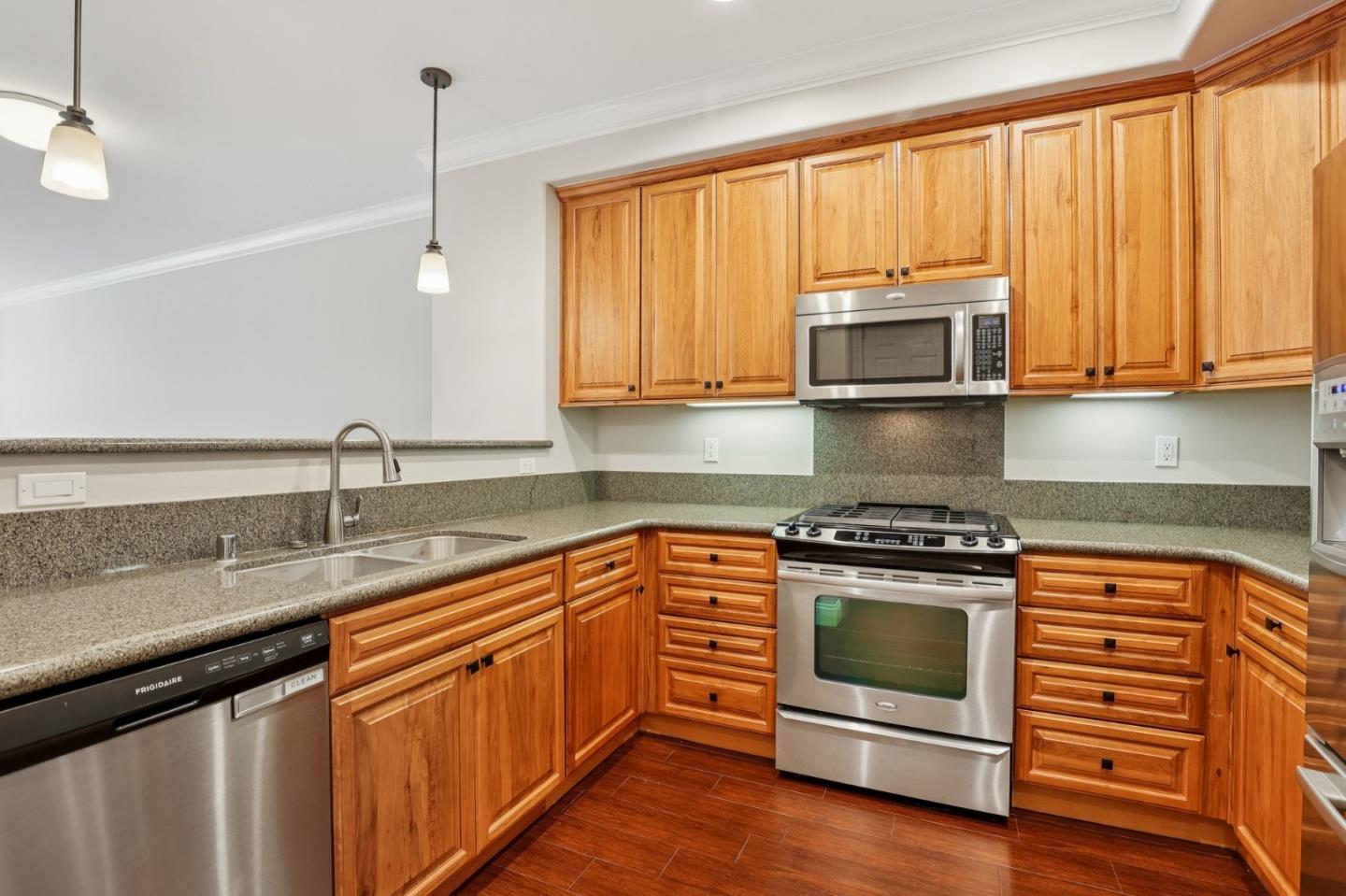 2881 Meridian Avenue, Unit 146 San Jose, CA 95124 - Photo 12 of 35 a kitchen with granite countertop a stove top oven sink and cabinets