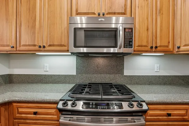 a stove top oven sitting inside of a kitchen