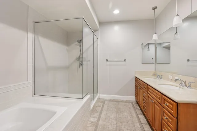 a bathroom with a double vanity sink and mirror