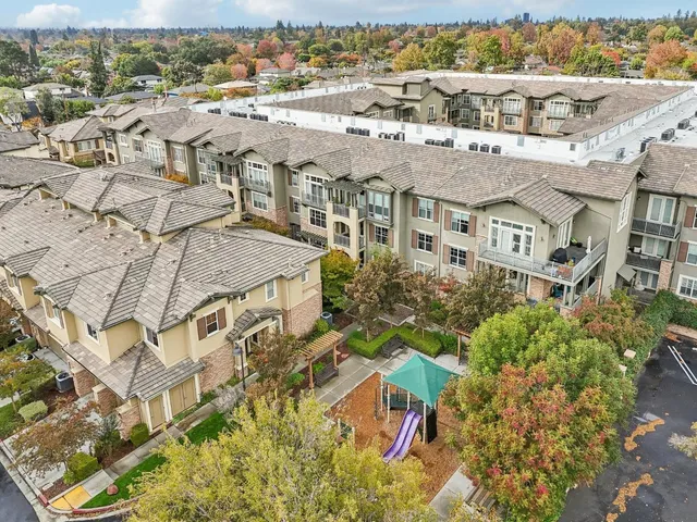 an aerial view of residential houses with outdoor space