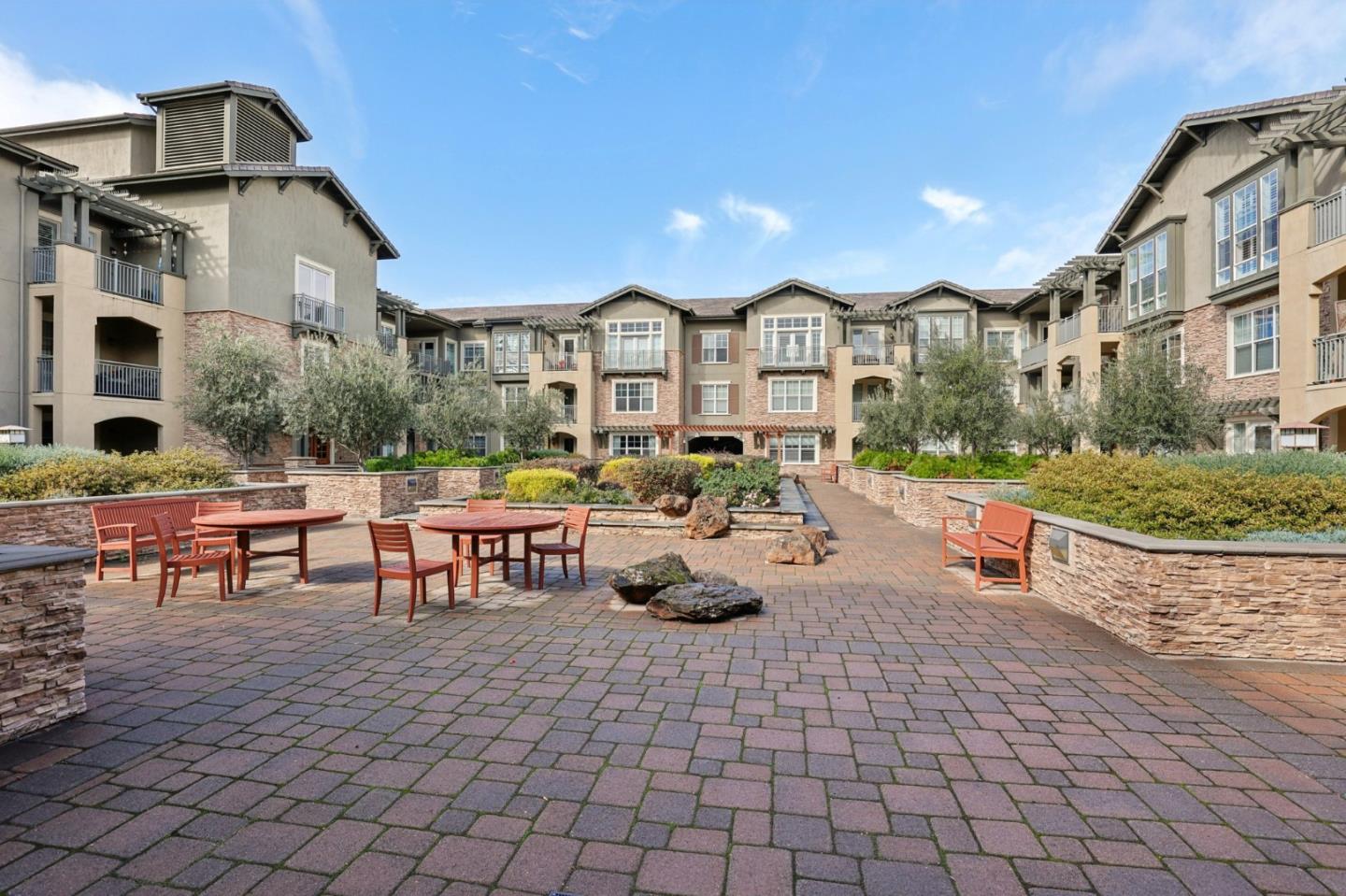 2881 Meridian Avenue, Unit 146 San Jose, CA 95124 - Photo 30 of 35 a view of a patio with dining table and chairs with plants and palm trees