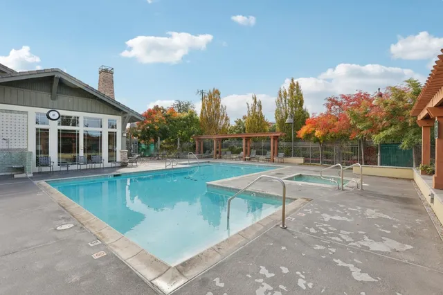 a view of a house with swimming pool and sitting area