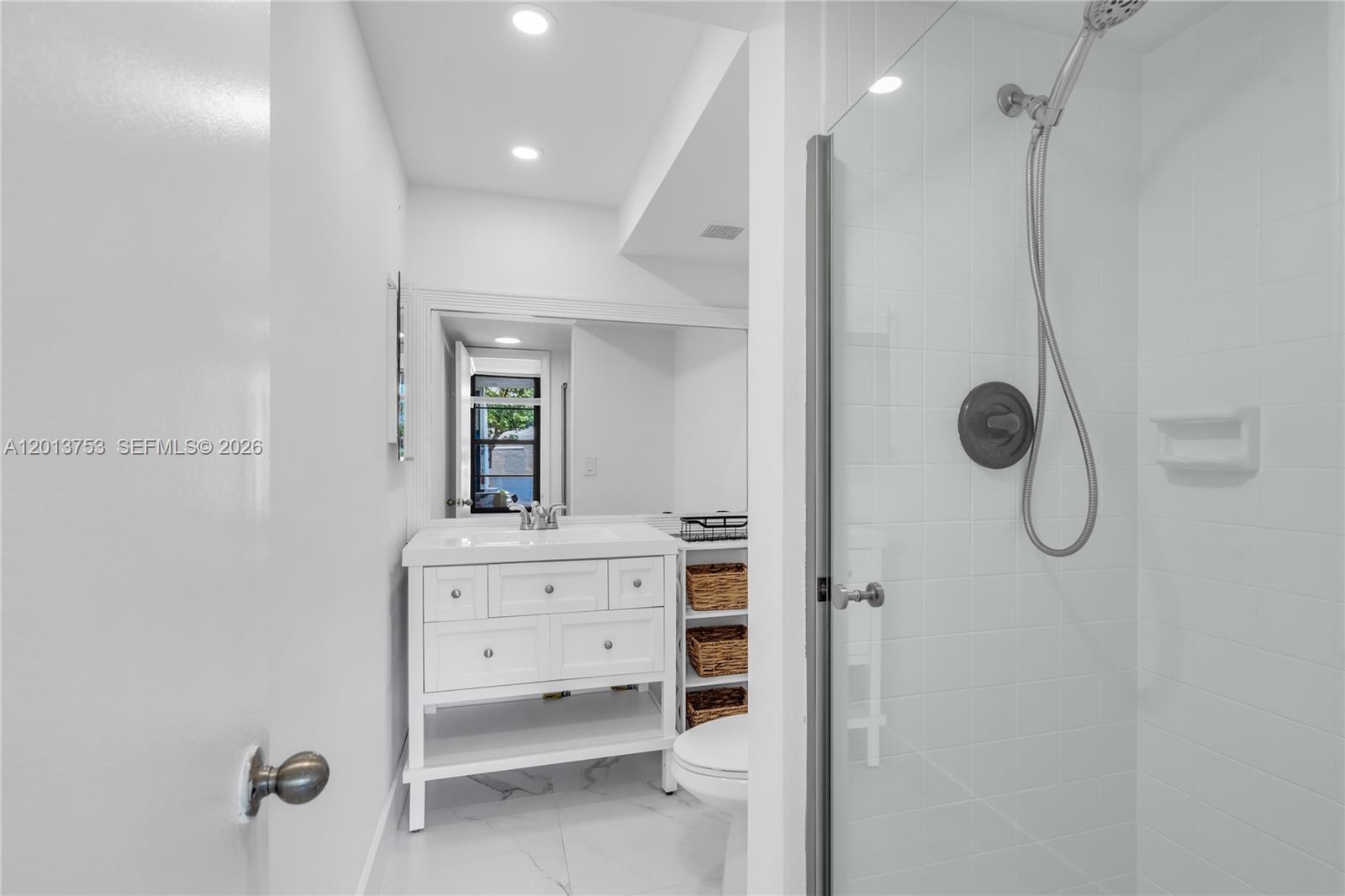 12 Royal Palm Way, Unit 103 Boca Raton, FL 33432 - Photo 14 of 22 a bathroom with a shower a sink and mirror