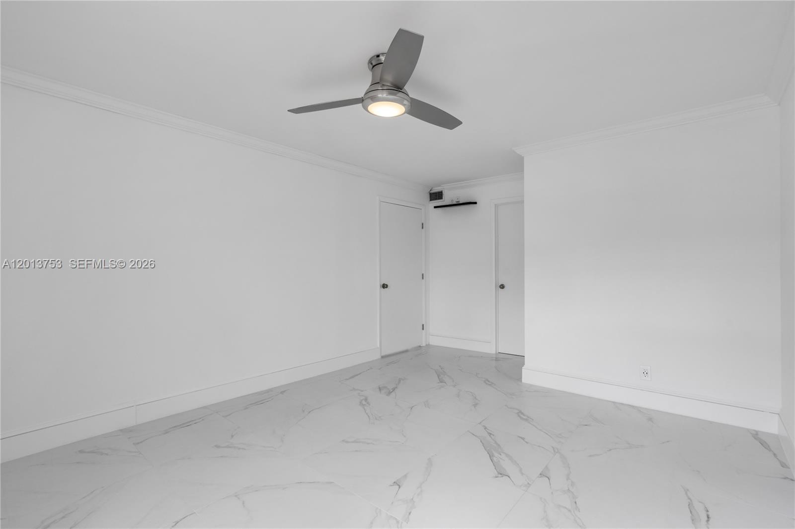 12 Royal Palm Way, Unit 103 Boca Raton, FL 33432 - Photo 8 of 22 an empty room with a ceiling fan and window