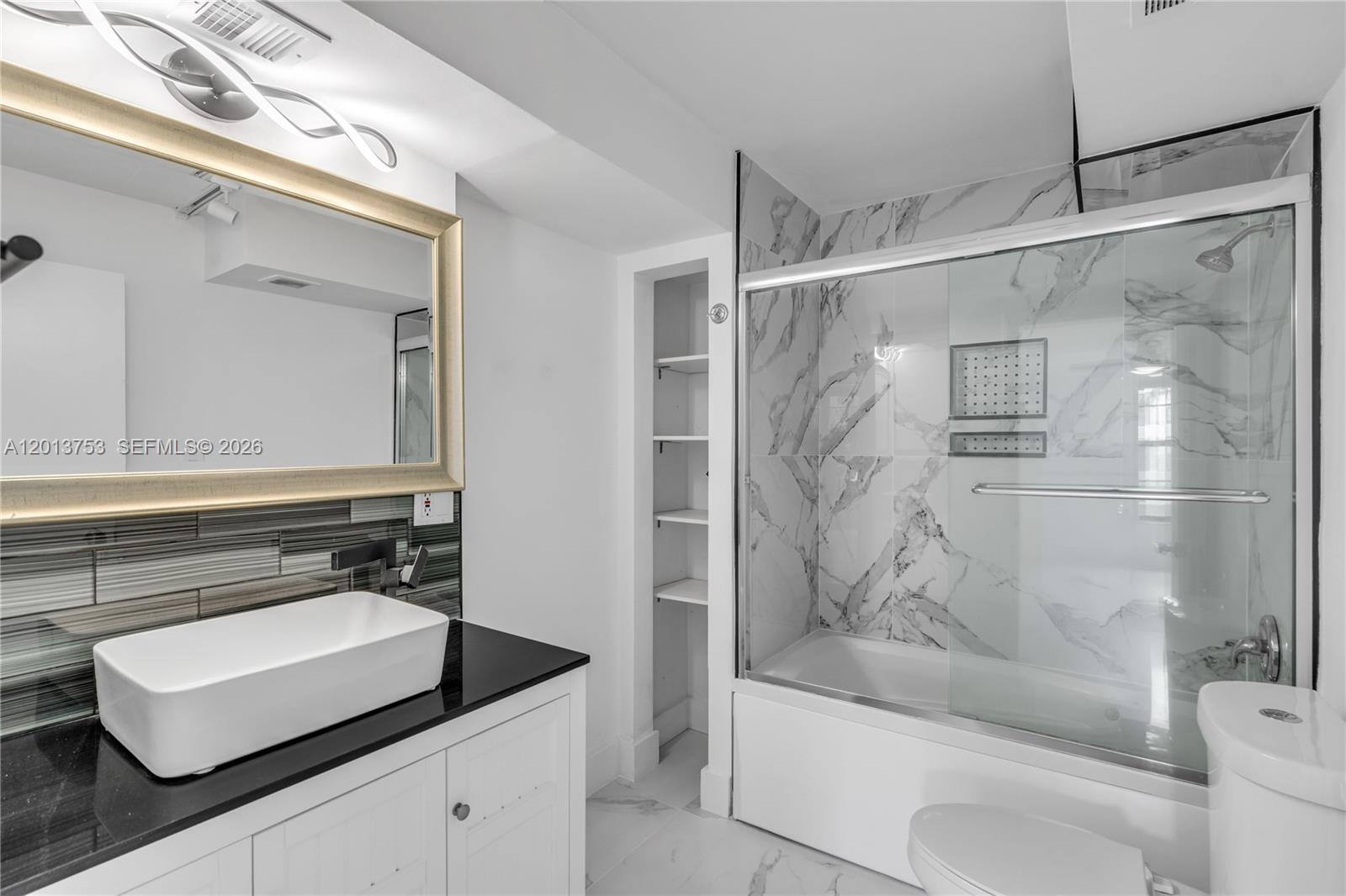 12 Royal Palm Way, Unit 103 Boca Raton, FL 33432 - Photo 10 of 22 a bathroom with a granite countertop sink a toilet and shower