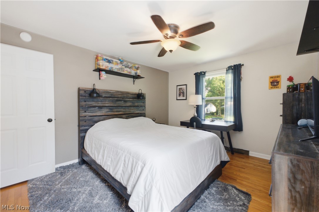2411 Ridgeview Lane Youngstown, OH 44514 - Photo 23 of 48 Bedroom featuring wood-finish flooring, a ceiling fan with integrated lighting, and a window with natural light