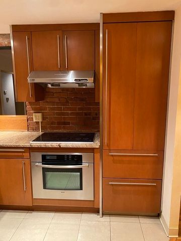 a stove top oven sitting inside of a kitchen