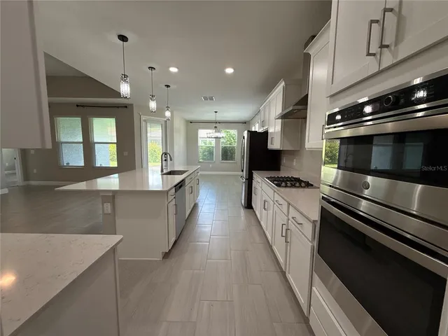 a large kitchen with stainless steel appliances