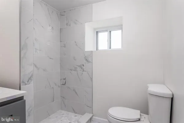 a white toilet sitting next to a bathroom sink