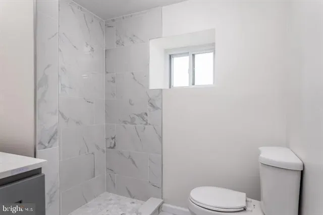 a white toilet sitting next to a bathroom sink