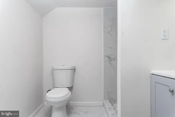 a white toilet sitting next to a white sink