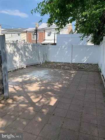 a view of a yard with brick wall