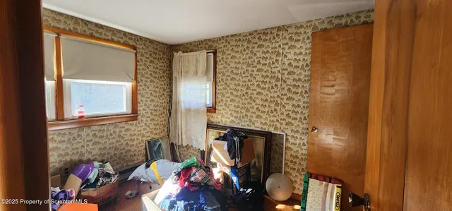 a view of a livingroom with wooden floor and a window