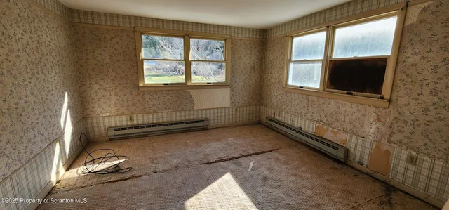 a room with table chairs and windows