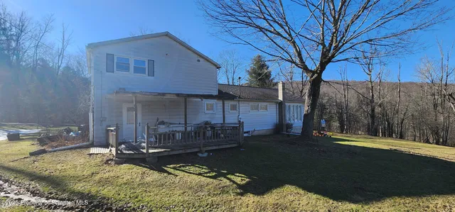a view of a house with backyard and sitting area