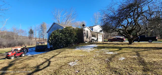 a view of yard with swimming pool and trees