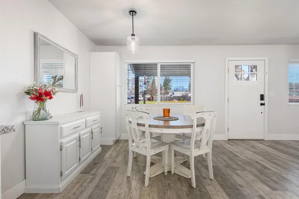 a view of a dining room with furniture and wooden floor