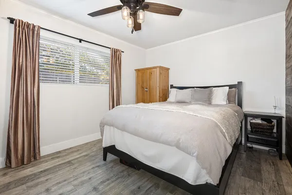 a large bed sitting in a bedroom next to a window