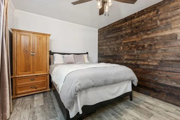 a bed sitting in a bedroom next to a bathroom