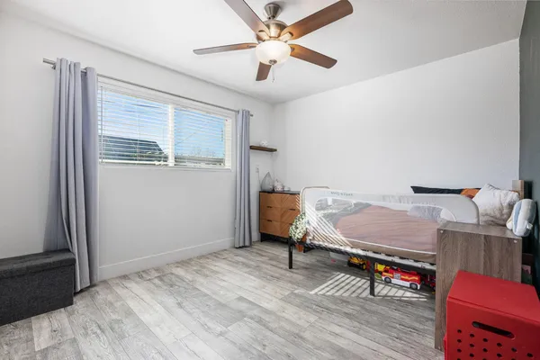 a bedroom with furniture and a window