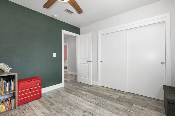 a view of room with hardwood floor and cabinet