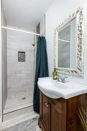 a bathroom with a sink vanity and a mirror