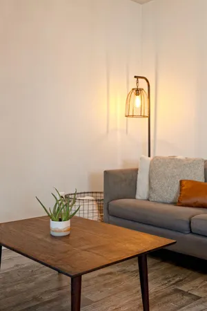 a living room with furniture and wooden floor