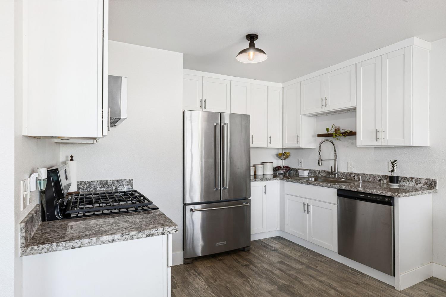 30 3rd Avenue Isleton, CA 95641 - Photo 9 of 42 a kitchen with stainless steel appliances granite countertop a stove a refrigerator and a sink