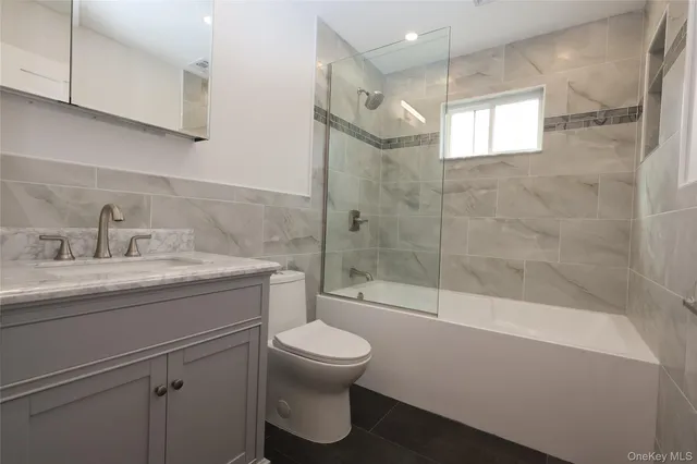 a bathroom with a shower a toilet and sink