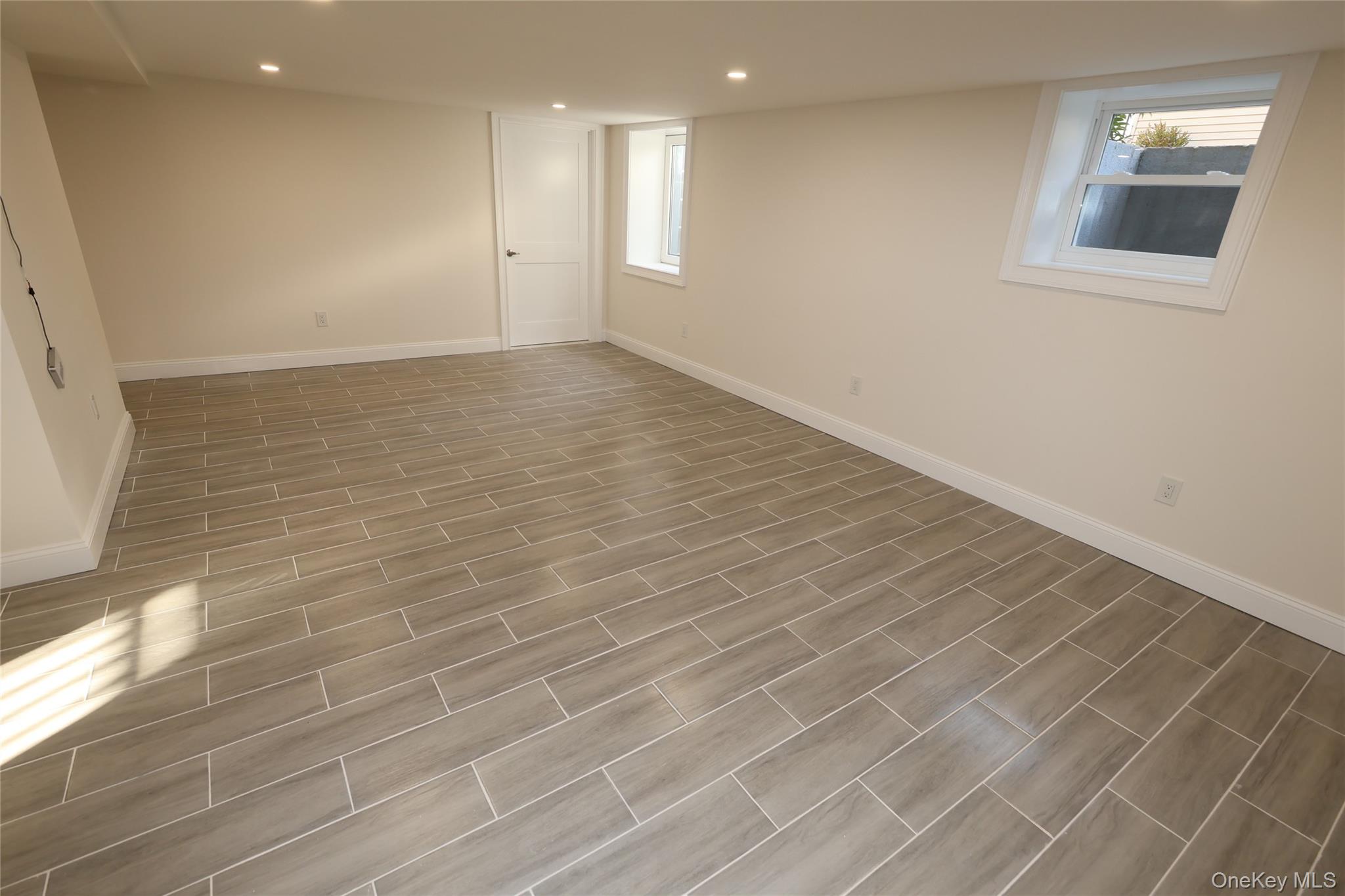 78 Ontario Road Floral Park, NY 11001 - Photo 20 of 38 a view of an empty room with wooden floor and a window